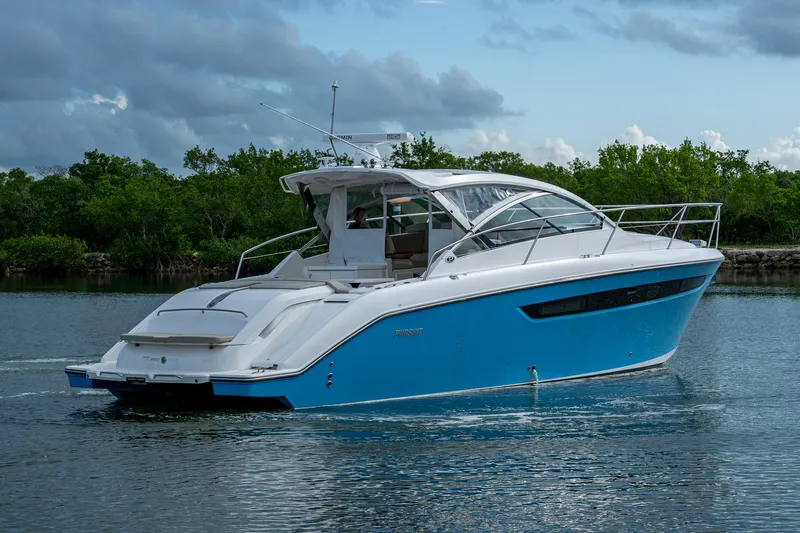  Yacht Photos Pics 2018 Pursuit SC 365i Sport Coupe cruising on a calm waterway.