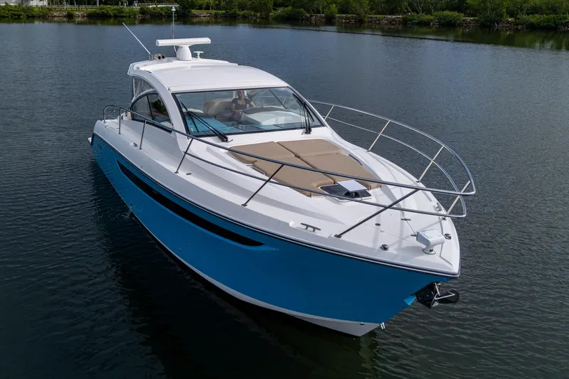  Yacht Photos Pics 2018 Pursuit SC 365i Sport Coupe cruising on a calm lake.