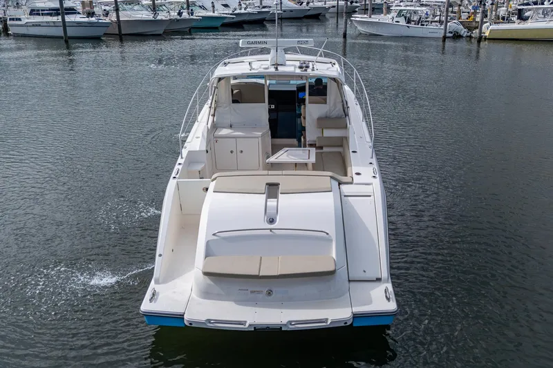  Yacht Photos Pics 2018 Pursuit SC 365i Sport Coupe yacht docked in marina, rear view.