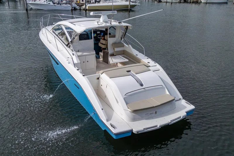  Yacht Photos Pics 2018 Pursuit SC 365i Sport Coupe cruising on calm waters, showcasing sleek design and luxury features.