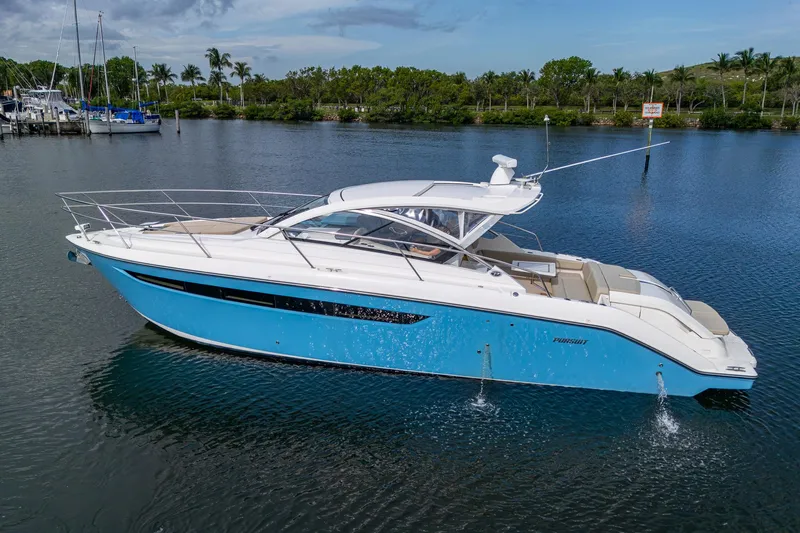  Yacht Photos Pics 2018 Pursuit SC 365i Sport Coupe yacht on calm water, featuring sleek design and blue hull.