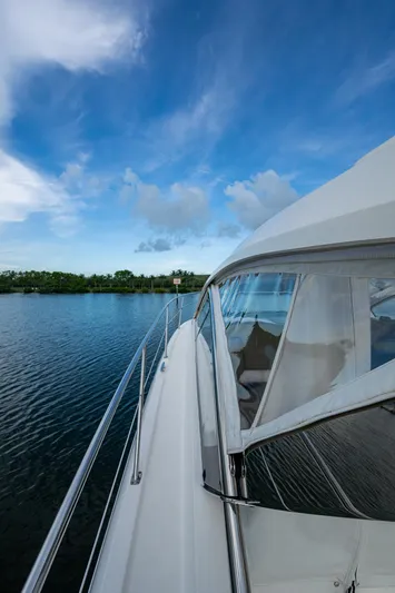  Yacht Photos Pics 2018 Pursuit SC 365i Sport Coupe on calm water under a clear blue sky.