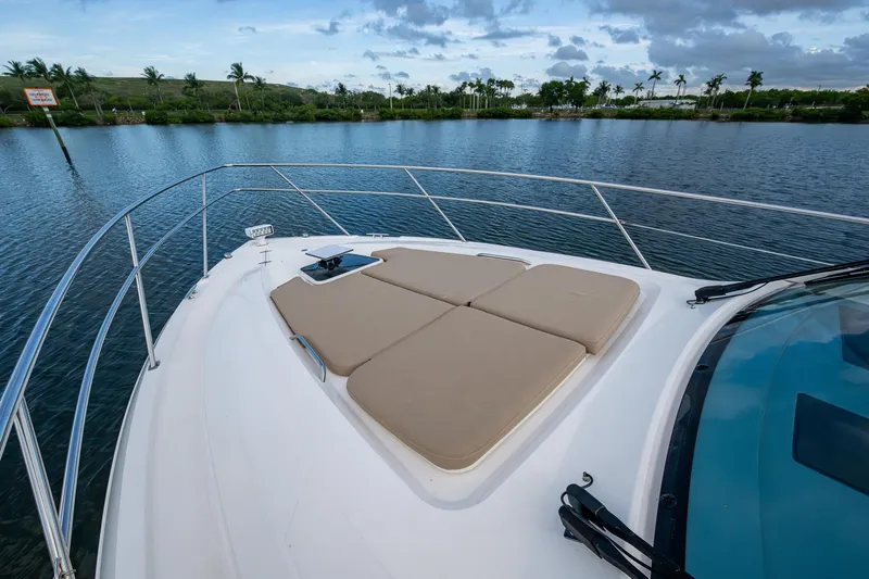 Yacht Photos Pics 2018 Pursuit SC 365i Sport Coupe on tranquil water, featuring spacious deck seating.