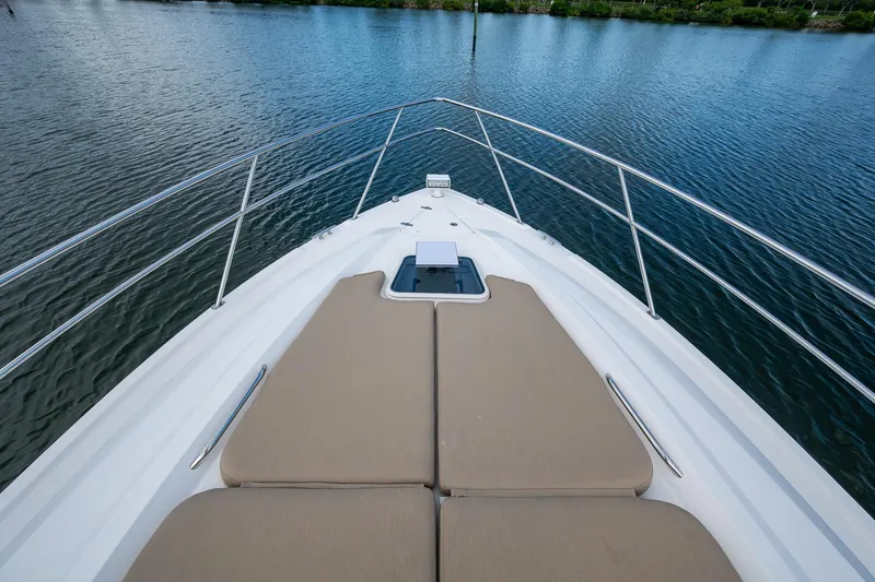  Yacht Photos Pics 2018 Pursuit SC 365i Sport Coupe bow with sun pads on calm water.