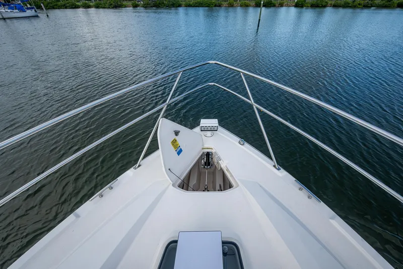  Yacht Photos Pics Bow view of 2018 Pursuit SC 365i Sport Coupe on calm water.