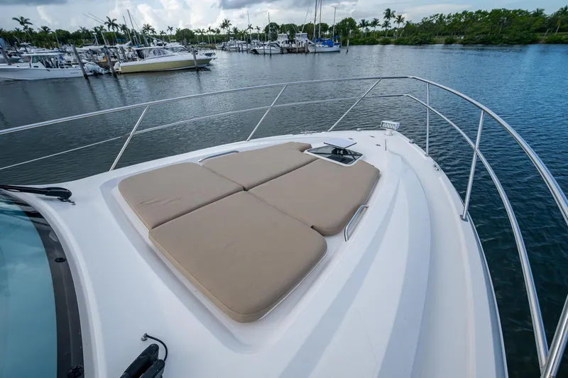  Yacht Photos Pics 2018 Pursuit SC 365i Sport Coupe with sunbathing cushions, docked in a marina.