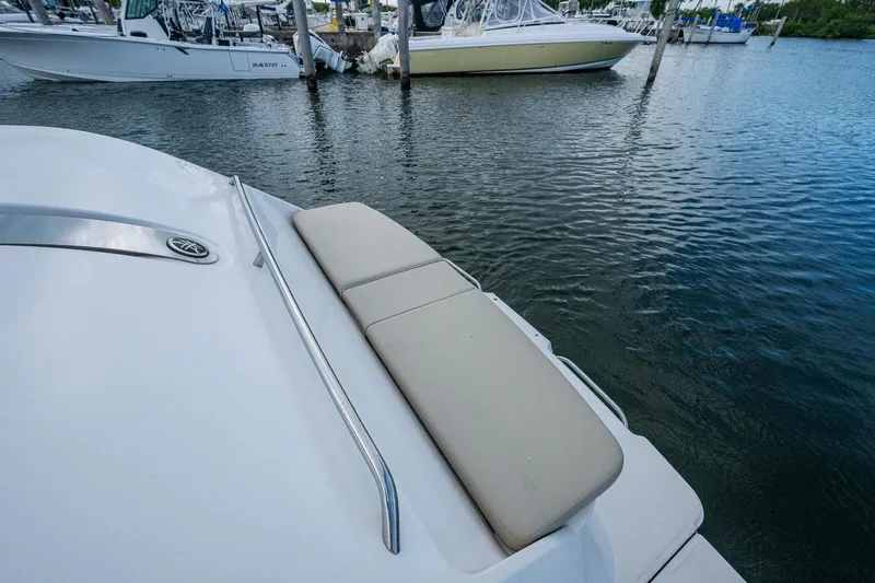  Yacht Photos Pics 2018 Pursuit SC 365i Sport Coupe docked, featuring a cushioned seating area.