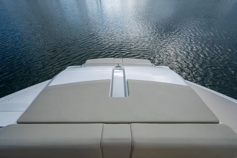  Yacht Photos Pics 2018 Pursuit SC 365i Sport Coupe sunpad overlooking calm water.