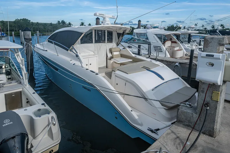  Yacht Photos Pics 2018 Pursuit SC 365i Sport Coupe docked at marina, surrounded by other boats.