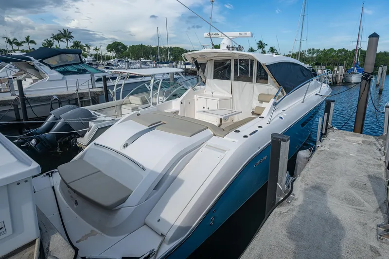  Yacht Photos Pics 2018 Pursuit SC 365i Sport Coupe docked at marina under blue sky.