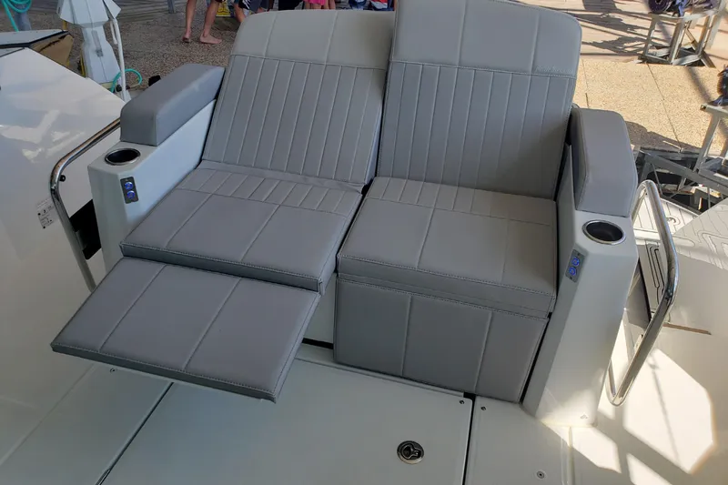 Tu Madre Yacht Photos Pics Luxury seating on 2019 Beneteau Gran Turismo 46 yacht, featuring gray upholstery and cup holders.