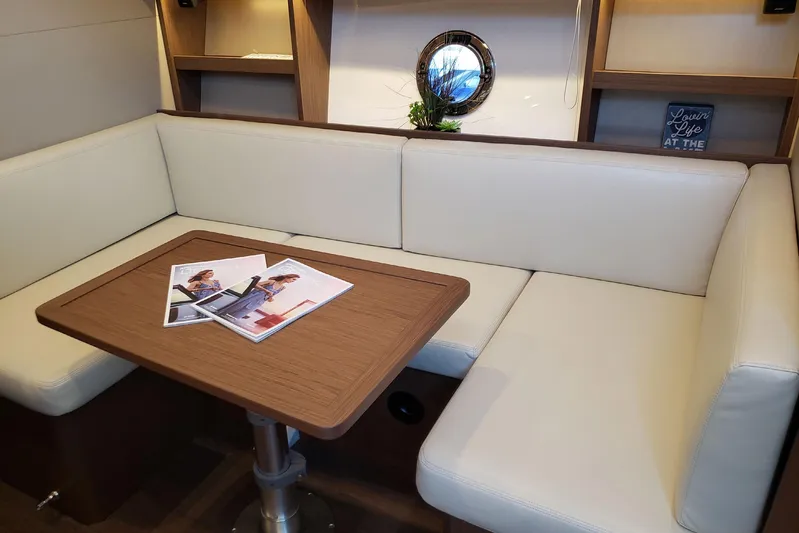 Tu Madre Yacht Photos Pics Luxurious interior of 2019 Beneteau Gran Turismo 46 yacht with elegant seating and table.