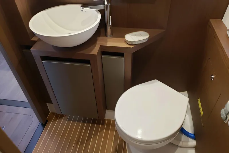 Tu Madre Yacht Photos Pics Bathroom interior of 2019 Beneteau Gran Turismo 46 yacht with modern sink and toilet.