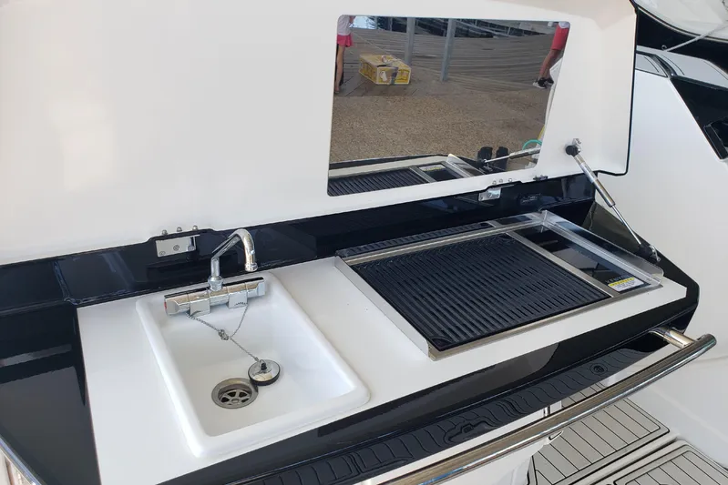 Tu Madre Yacht Photos Pics Outdoor kitchen on 2019 Beneteau Gran Turismo 46 yacht with sink and grill.