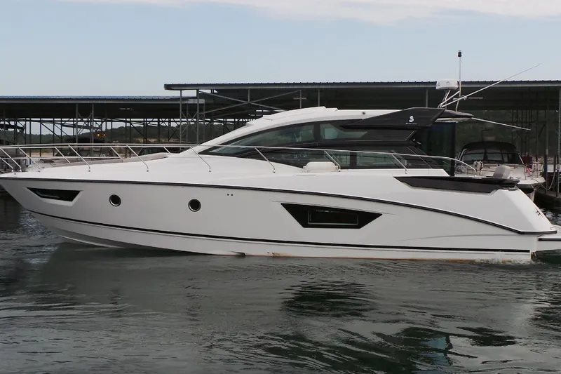 Tu Madre Yacht Photos Pics 2019 Beneteau Gran Turismo 46 yacht docked in a marina, side view.