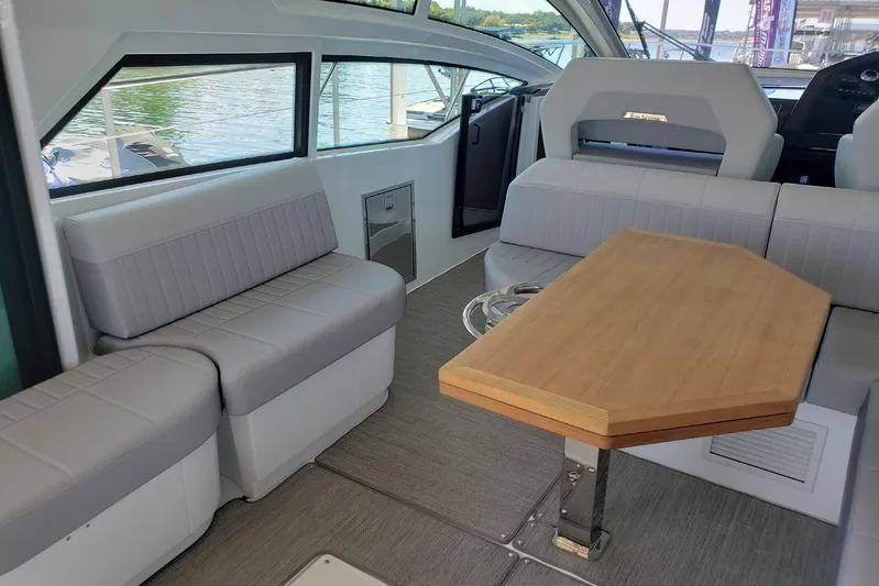 Tu Madre Yacht Photos Pics Interior of 2019 Beneteau Gran Turismo 46 yacht with seating and wooden table.
