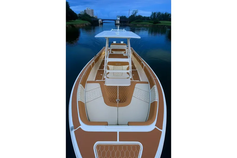  Yacht Photos Pics 2019 Century 3200 Center Console boat on calm water, featuring spacious seating and sleek design.