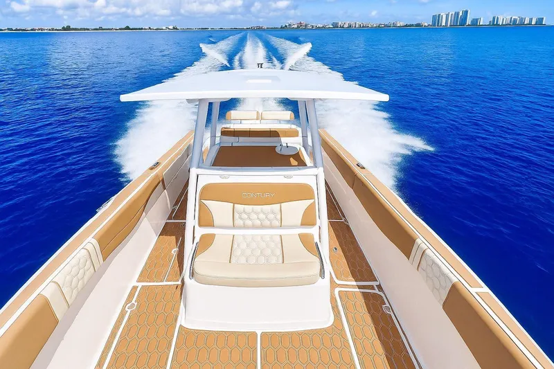  Yacht Photos Pics 2019 Century 3200 Center Console boat cruising on clear blue water.