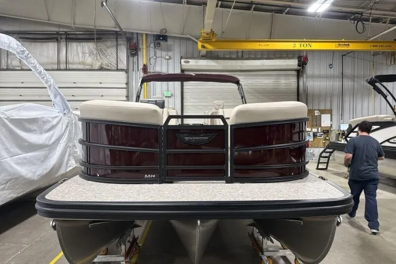 2026 Bennington 24 MOFBSF pontoon boat in a warehouse setting.