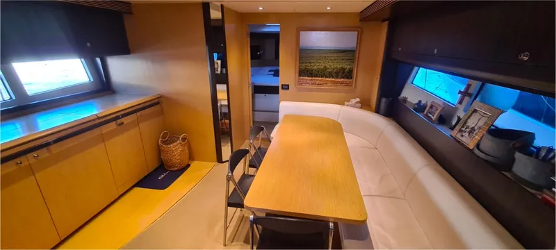  Yacht Photos Pics Interior of 2012 Riva 63 Virtus yacht with modern dining area and large windows.