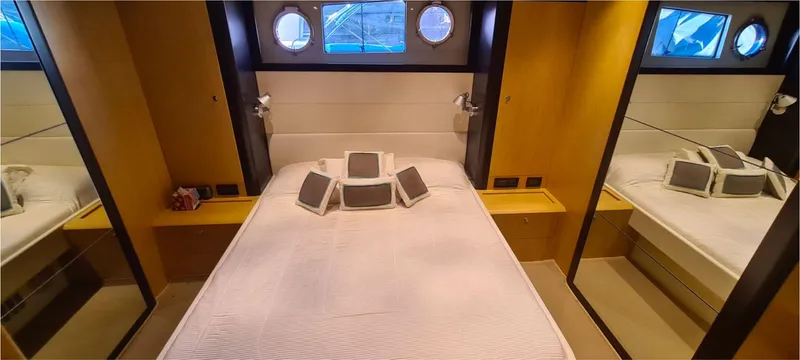  Yacht Photos Pics Luxurious bedroom interior of 2012 Riva 63 Virtus yacht with elegant bedding and porthole windows.