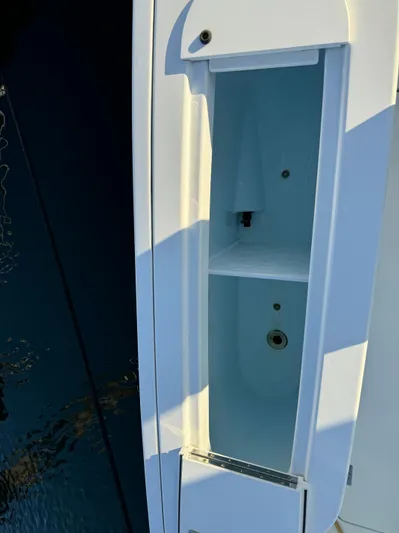  Yacht Photos Pics Open storage compartment on 2011 Rampage 34 IPS boat, showing interior details.