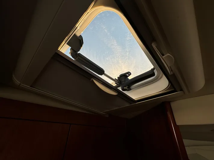  Yacht Photos Pics Open hatch on 2011 Rampage 34 IPS boat, showing sky view.