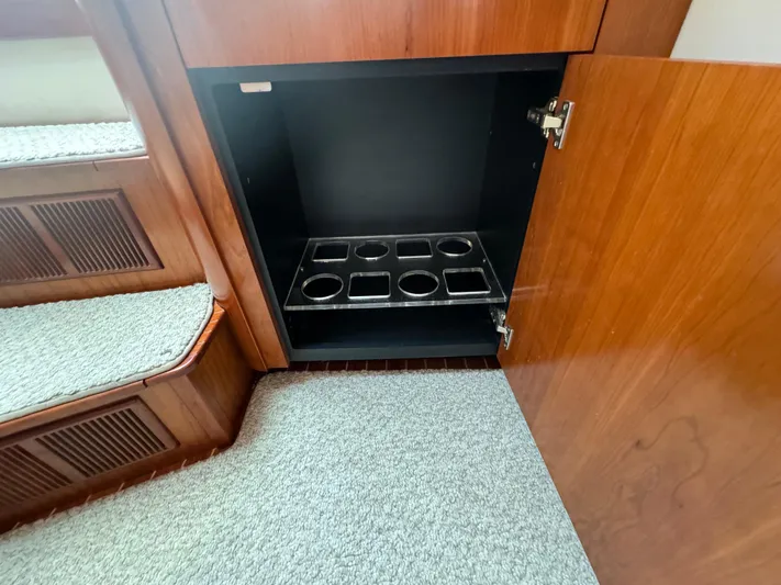  Yacht Photos Pics Open wooden cabinet with cup holders inside, Rampage 34 IPS 2011 boat interior.