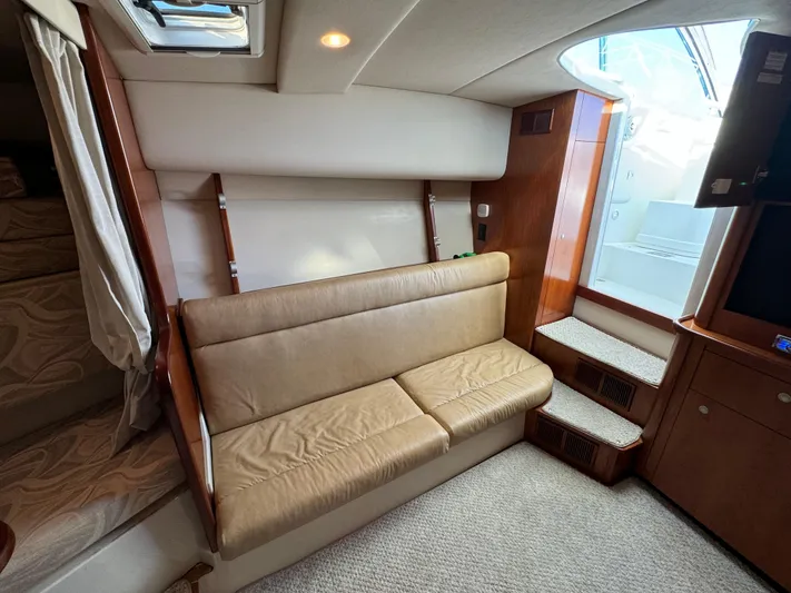  Yacht Photos Pics Interior of 2011 Rampage 34 IPS boat with beige seating and wooden accents.