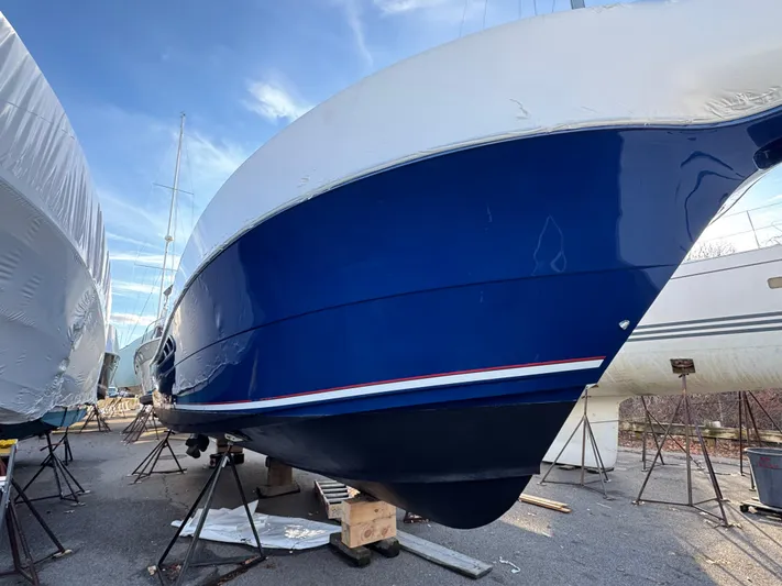  Yacht Photos Pics 2011 Rampage 34 IPS boat on stands, blue hull, outdoor storage.