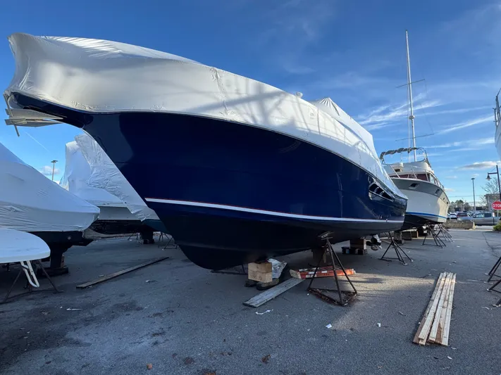  Yacht Photos Pics 2011 Rampage 34 IPS boat covered and docked on land.