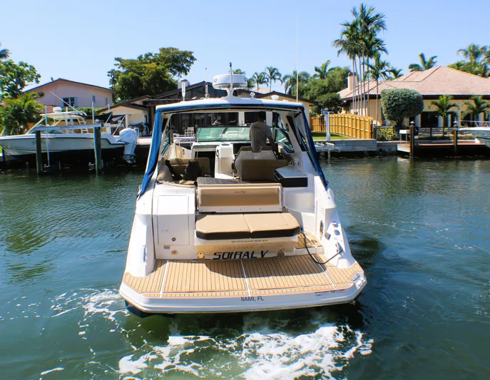 Soiral V Yacht Photos Pics 2021 Sea Ray 320 Sundancer yacht docked in a sunny marina.
