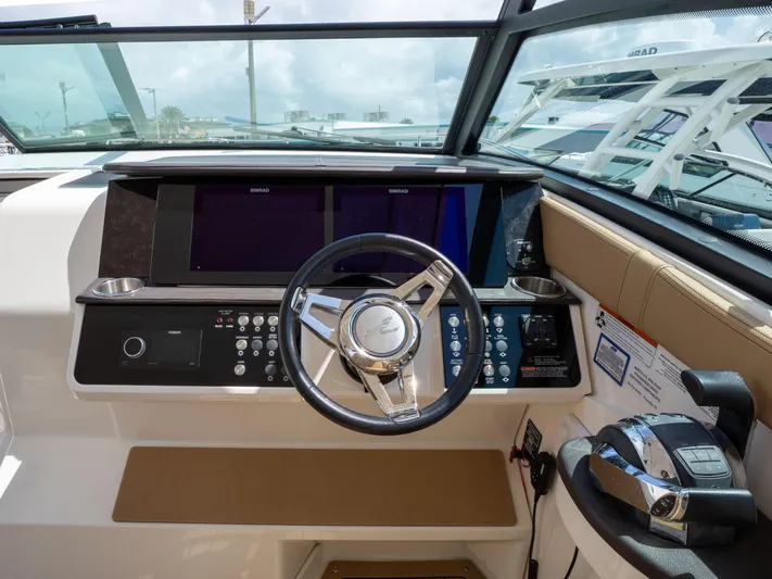 Soiral V Yacht Photos Pics 2021 Sea Ray 320 Sundancer helm with modern controls and navigation displays.