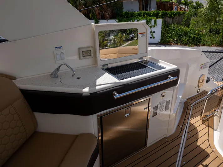 Soiral V Yacht Photos Pics Outdoor kitchenette on 2021 Sea Ray 320 Sundancer yacht with sink and grill.