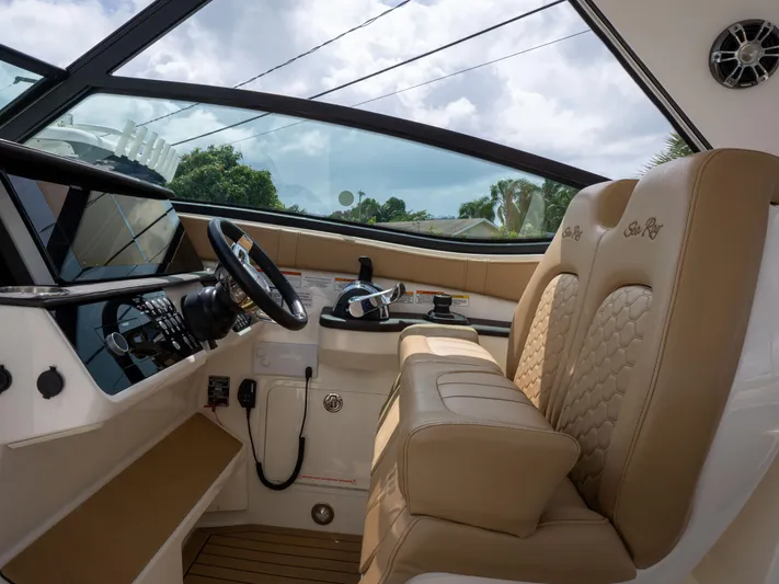 Soiral V Yacht Photos Pics Interior of 2021 Sea Ray 320 Sundancer boat with beige seating and modern controls.