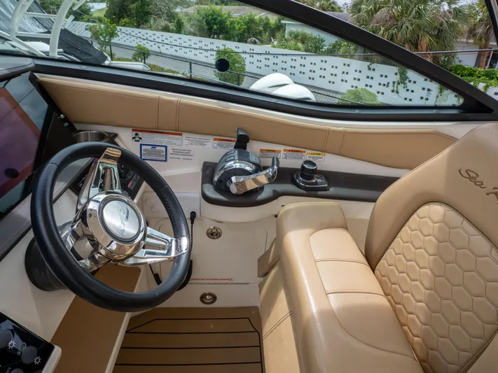 Soiral V Yacht Photos Pics 2021 Sea Ray 320 Sundancer helm with beige seating and modern steering wheel.