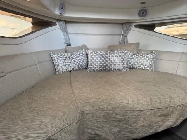 Soiral V Yacht Photos Pics Interior cabin of 2021 Sea Ray 320 Sundancer with cozy seating and decorative pillows.