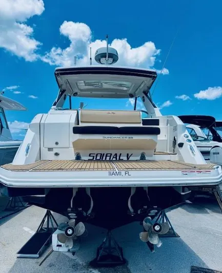 Soiral V Yacht Photos Pics 2021 Sea Ray 320 Sundancer yacht docked under a clear blue sky.
