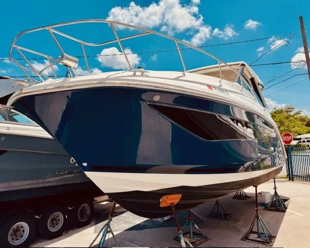 Soiral V Yacht Photos Pics 2021 Sea Ray 320 Sundancer boat on stands under a clear blue sky.