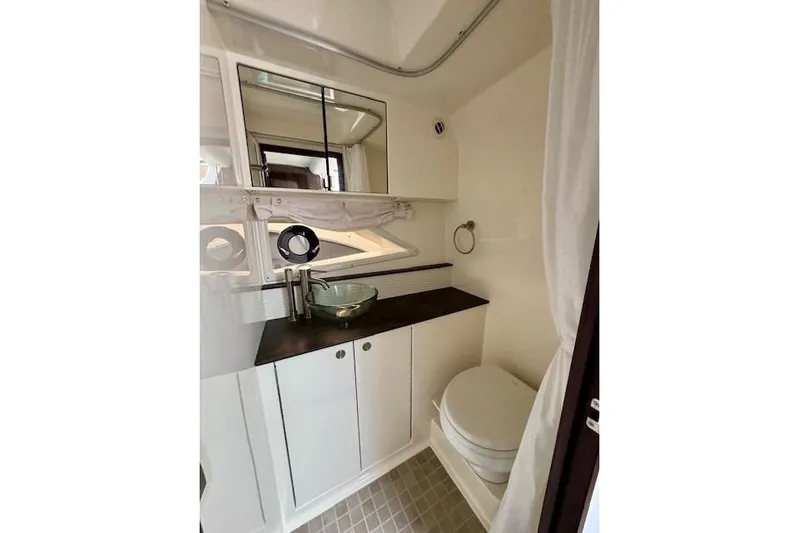 Soiral V Yacht Photos Pics 2021 Sea Ray 320 Sundancer bathroom with modern fixtures and glass sink.
