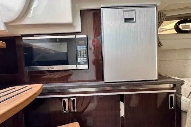 Soiral V Yacht Photos Pics Interior of 2021 Sea Ray 320 Sundancer with microwave and compact fridge.