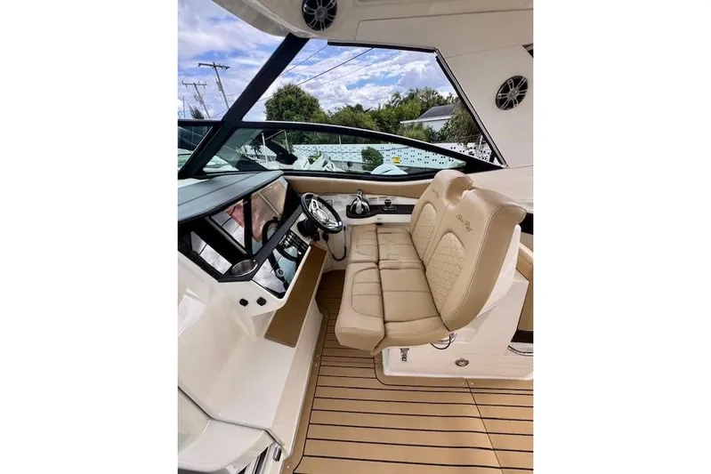 Soiral V Yacht Photos Pics Interior of 2021 Sea Ray 320 Sundancer boat with beige seating and modern dashboard.