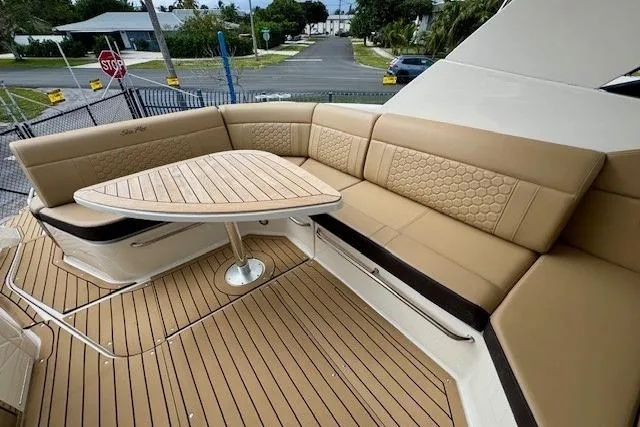 Soiral V Yacht Photos Pics Luxurious seating area on 2021 Sea Ray 320 Sundancer yacht with elegant wood table.