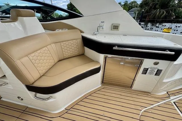 Soiral V Yacht Photos Pics Luxurious seating and kitchenette on 2021 Sea Ray 320 Sundancer yacht deck.