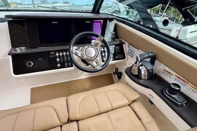 Soiral V Yacht Photos Pics Cockpit of 2021 Sea Ray 320 Sundancer with modern controls and leather seating.