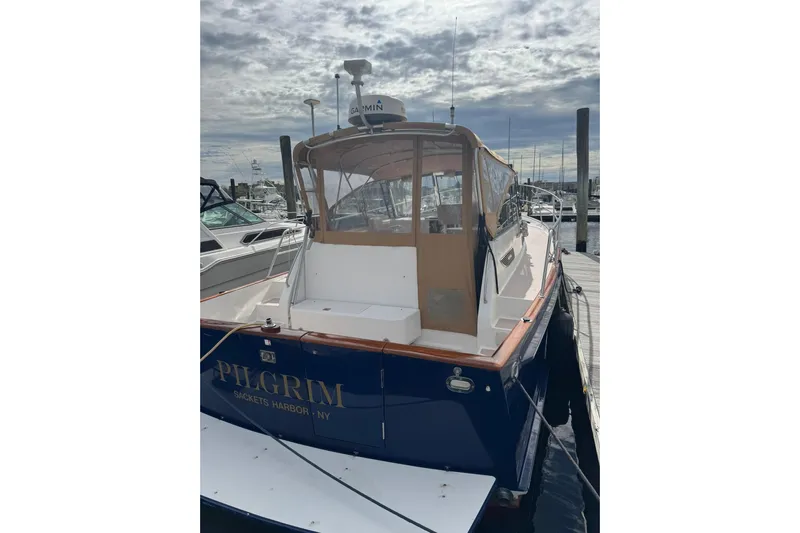 Pilgrim Yacht Photos Pics 2001 Legacy Soft Top boat docked at marina, named "Pilgrim," Sackets Harbor, NY.