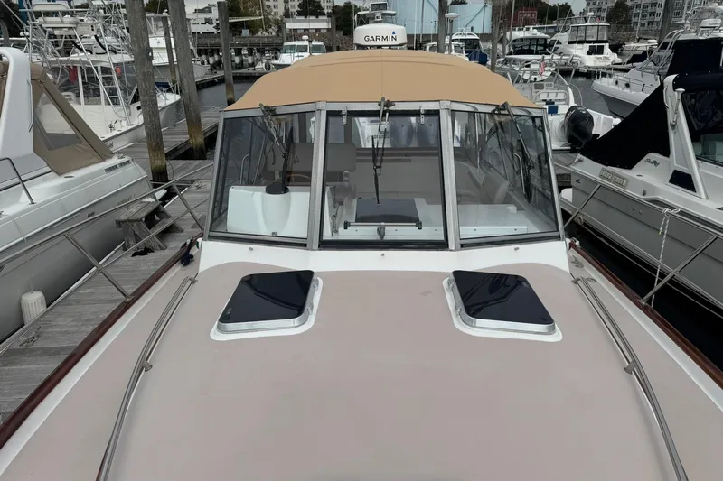 Pilgrim Yacht Photos Pics 2001 Legacy Soft Top boat docked at marina, featuring beige canopy and sleek design.