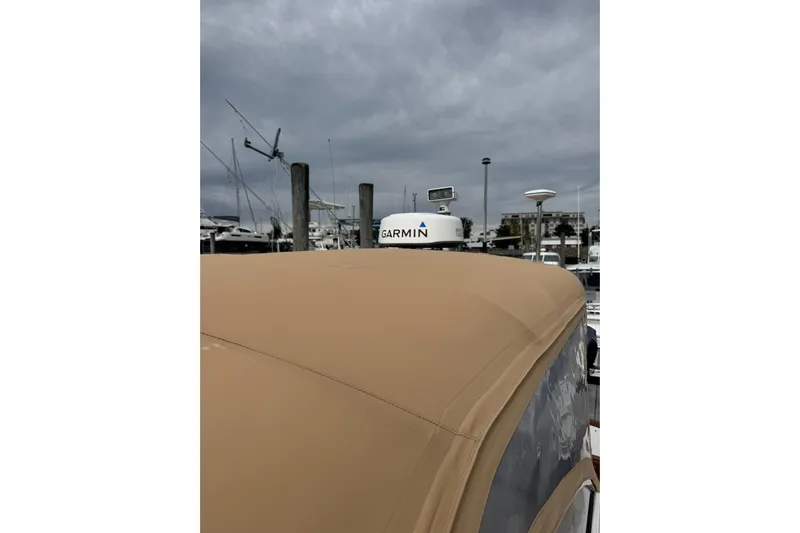 Pilgrim Yacht Photos Pics 2001 Legacy Soft Top boat with Garmin equipment under cloudy sky at marina.