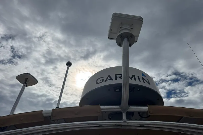 Pilgrim Yacht Photos Pics 2001 Legacy Soft Top boat with Garmin radar against cloudy sky.