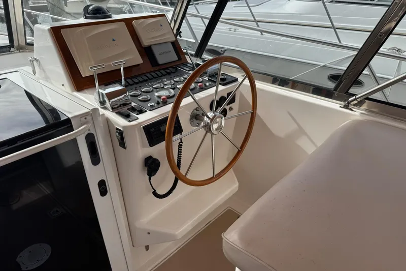 Pilgrim Yacht Photos Pics 2001 Legacy Soft Top boat helm with wooden steering wheel and navigation controls.